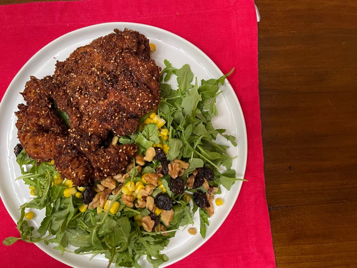 crispy sesame fried chicken over summer salad
